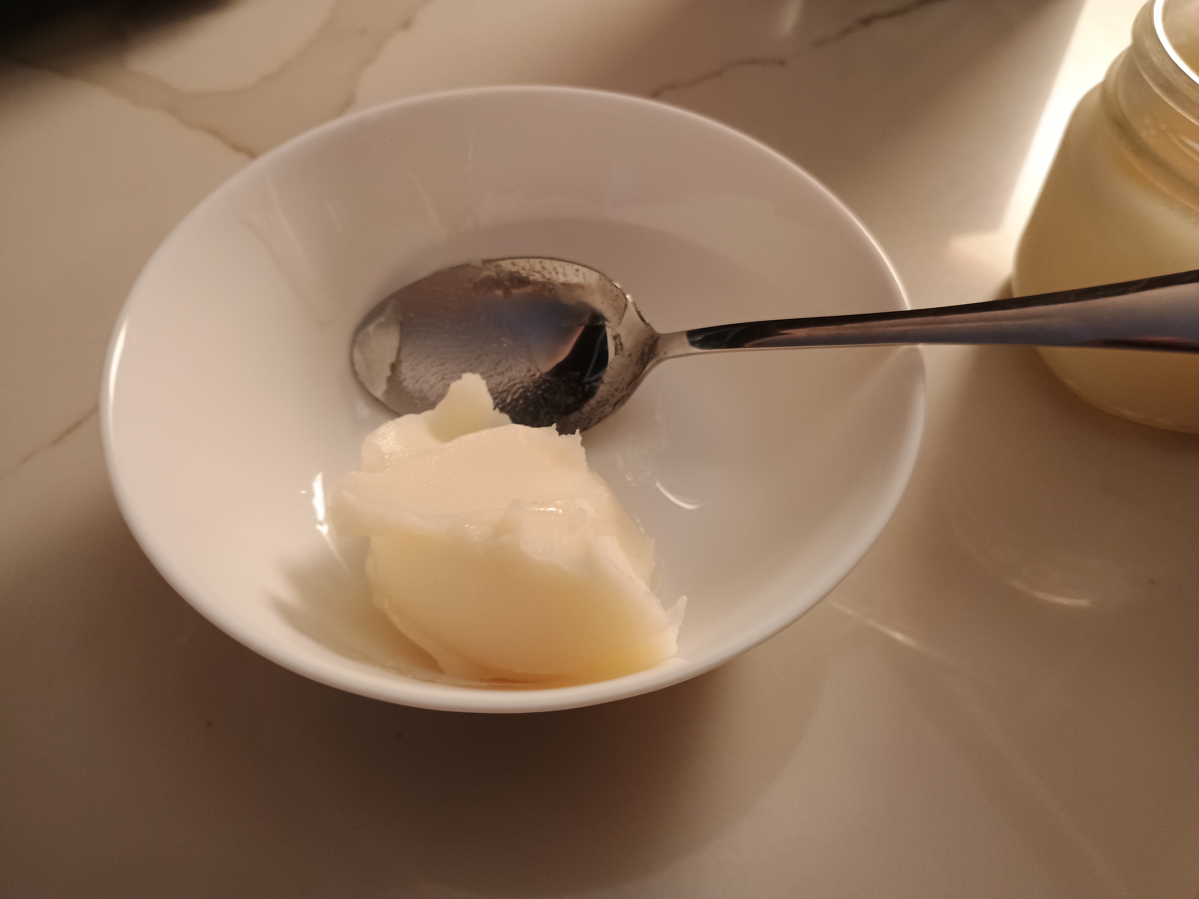 一勺熊油和一​​把勺子放在碗里。